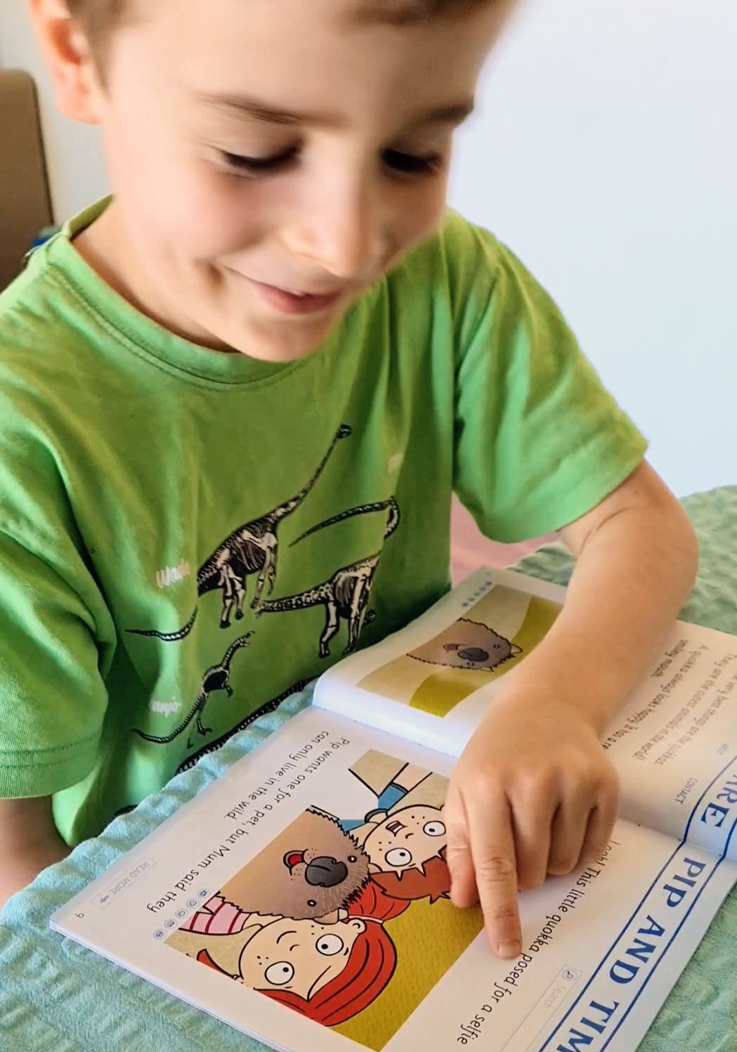 Child reading a Sounds-Write decodable reader at home